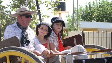 Niños y mujeres al frente de los caballos